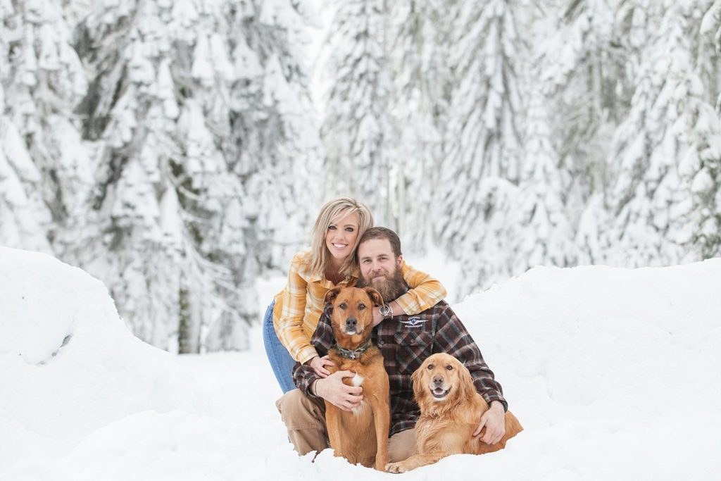 cute couple with dogs in the snow