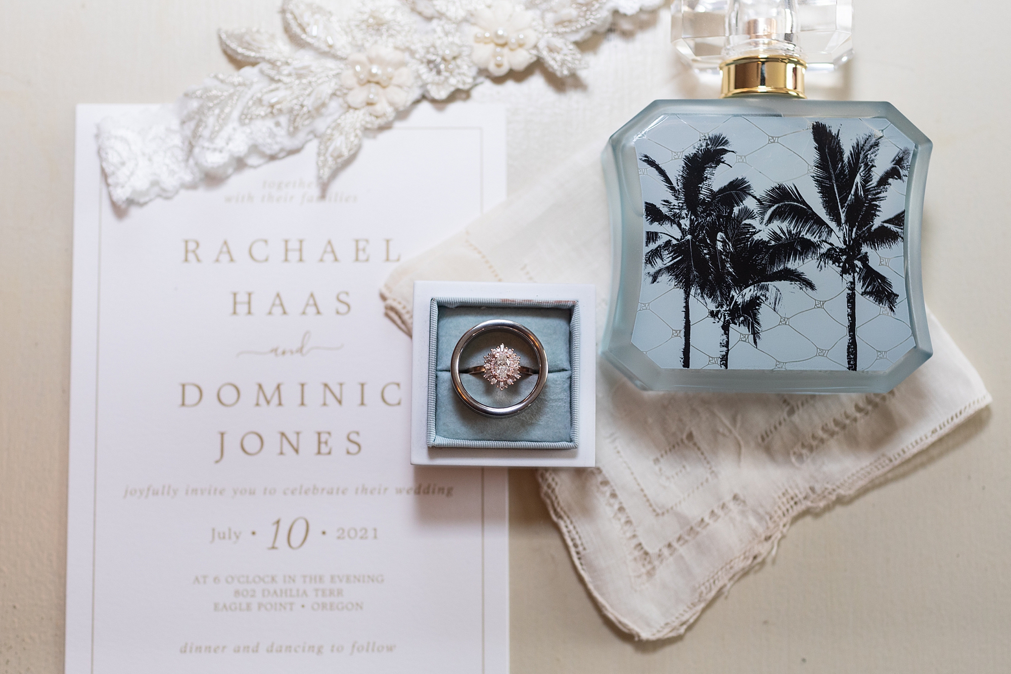 wedding rings, invitation and perfume