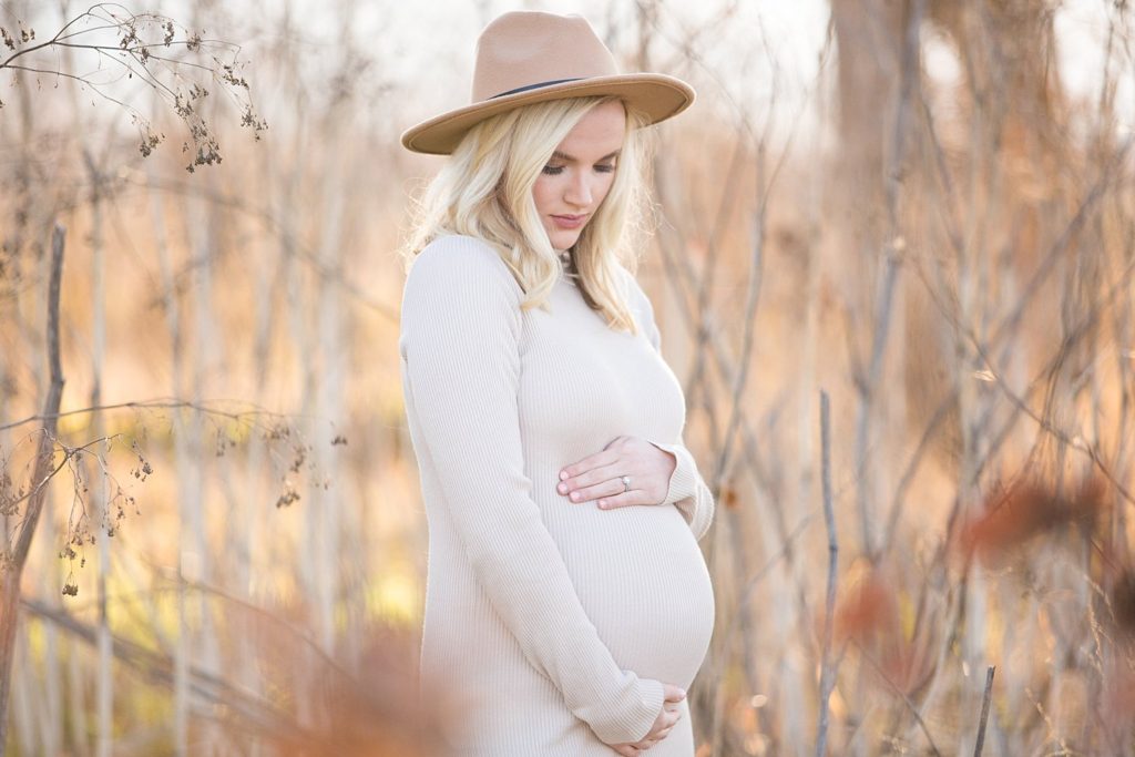 pregnant woman with fitted dress and cute hat