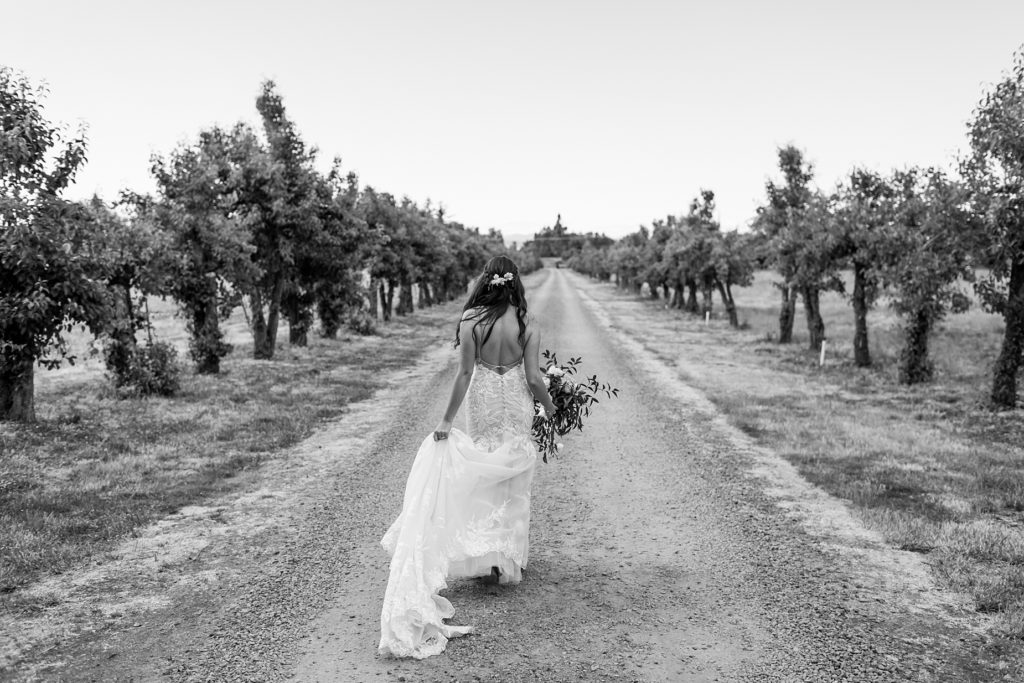 bride walking away in orchard