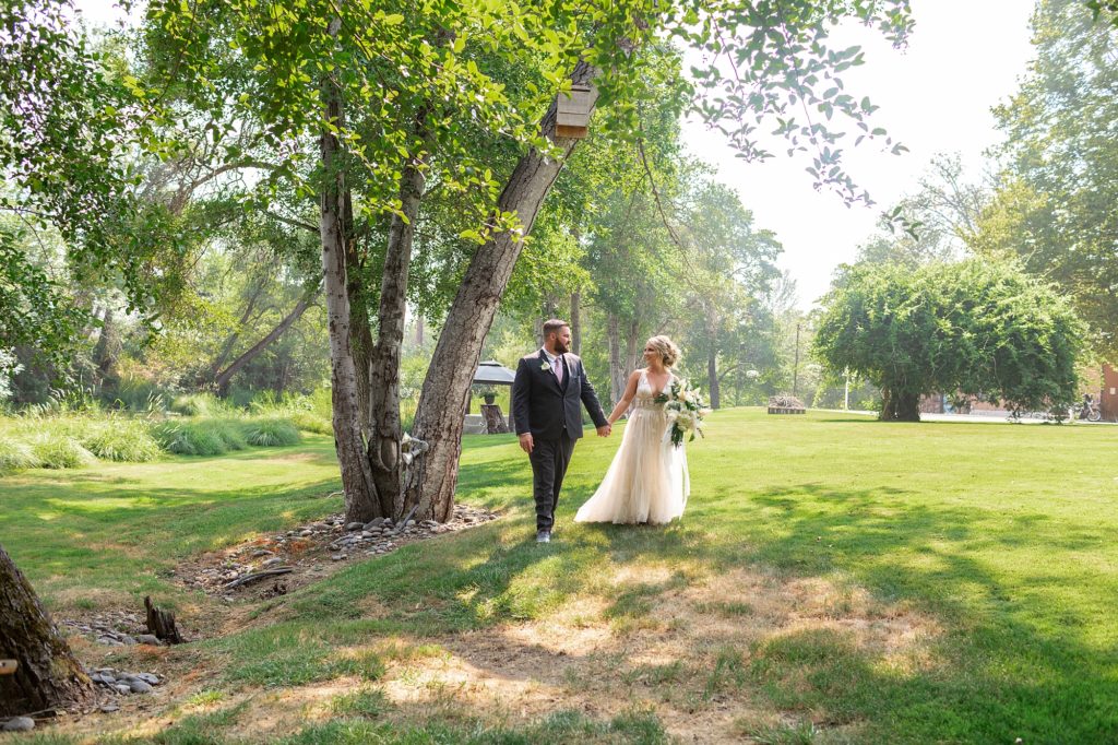 bride and groom walking on grass