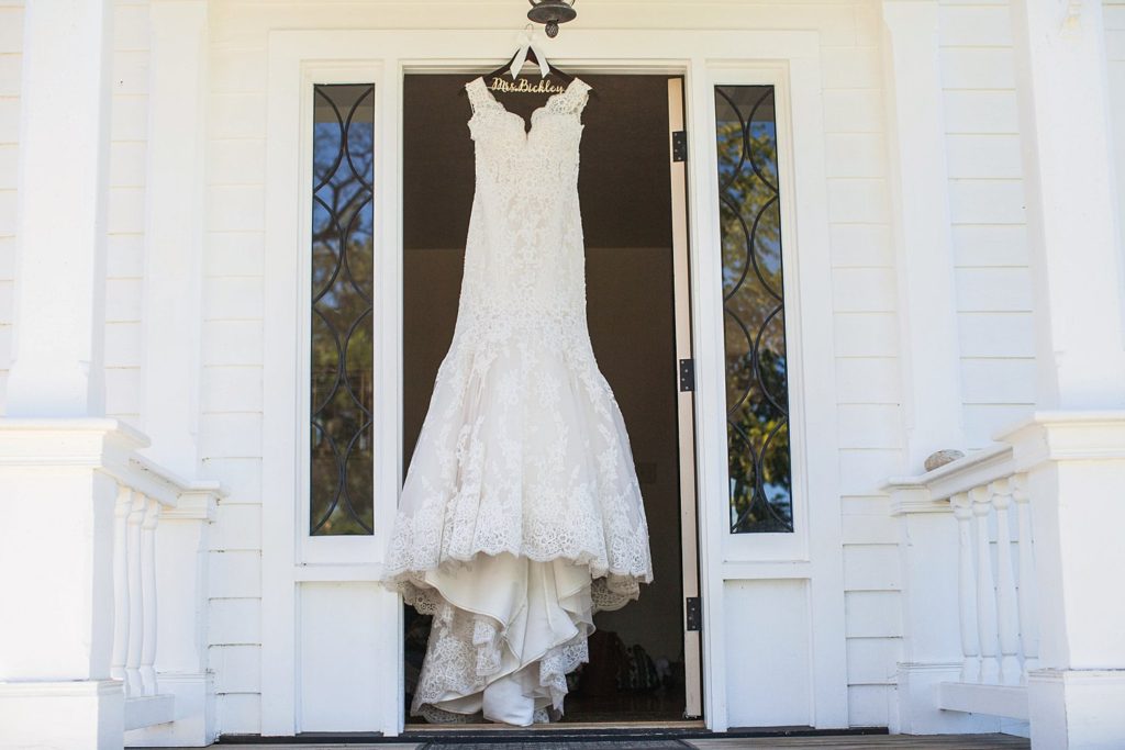 wedding dress hanging on front door