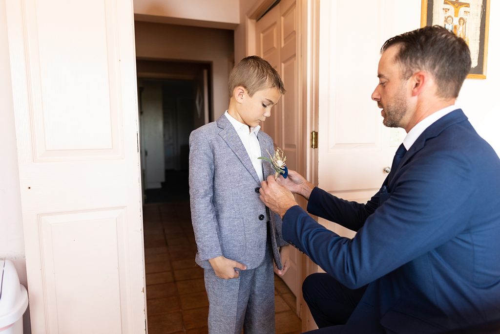 groom and son prepping for wedding day