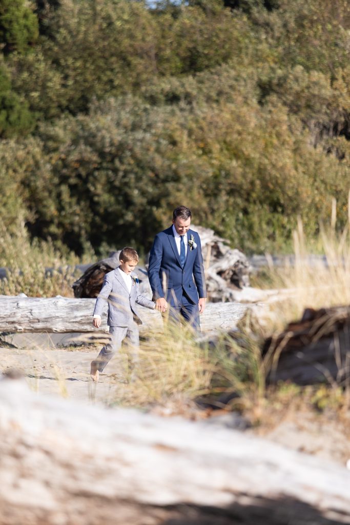 groom and son walking to the wedding ceremony on the beach