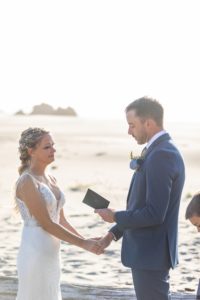 groom saying his vows during beach wedding