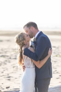 first kiss on the beach on wedding day