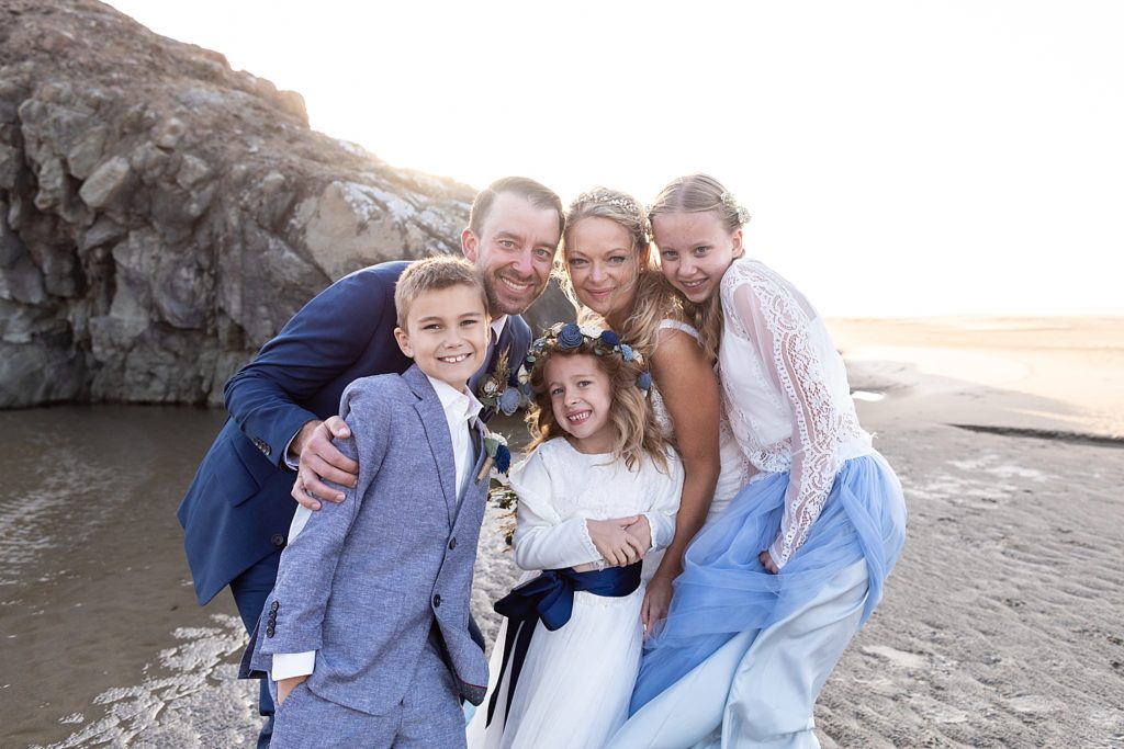 family picture on wedding day on the beach