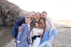 family picture on wedding day on the beach