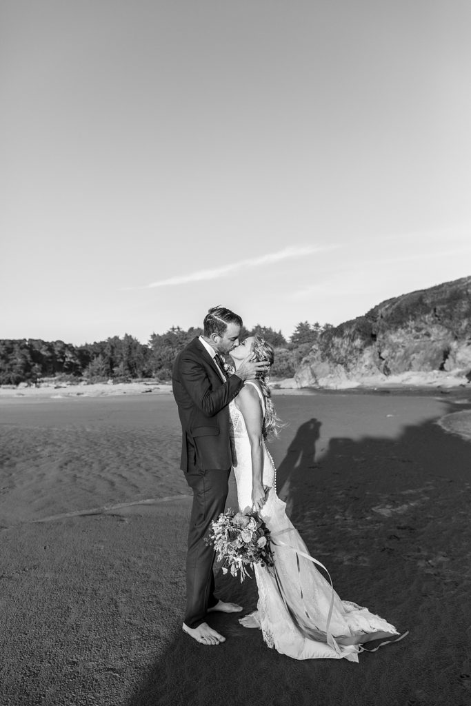 newlyweds kissing on the Oregon coast beach