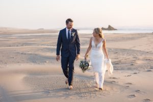 newlyweds walking on the beach